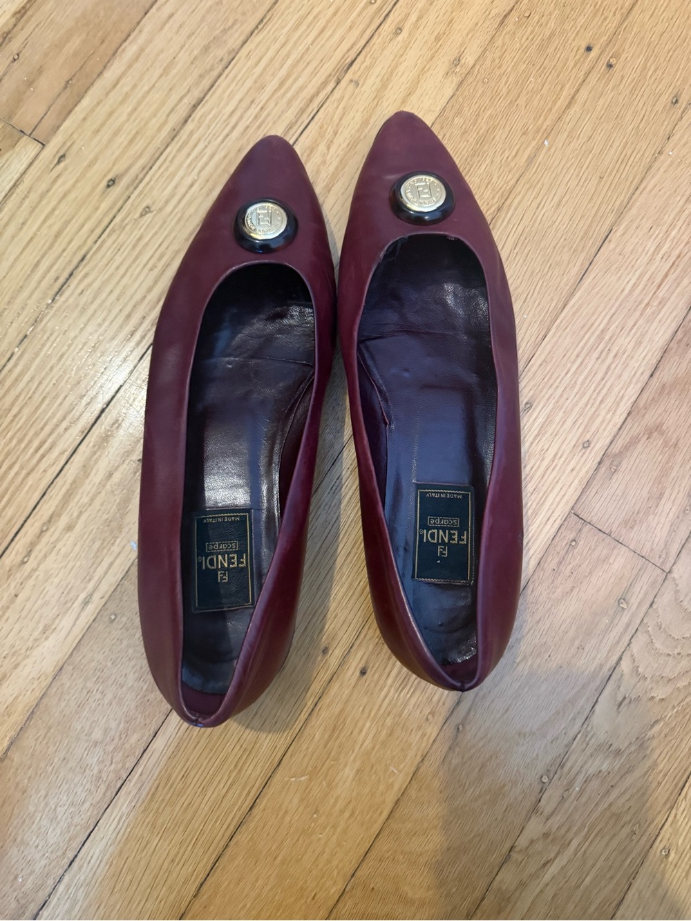 Fendi Burgundy Leather Pointed Ballet Flats with Gold Medallion